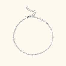 Load image into Gallery viewer, Silver bracelet on a light yellow background
