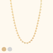 Load image into Gallery viewer, Gold heart chain necklace on a light yellow background with color swatches below.