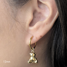 Load image into Gallery viewer, Gold hoop earring with a bear charm worn by a person
