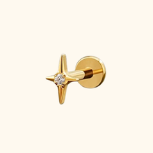 Load image into Gallery viewer, Gold earring with star design and clear cubic zirconia stone on a light yellow background

