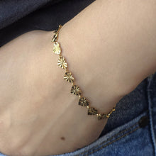 Load image into Gallery viewer, Gold bracelet on a person's wrist with denim jeans in the background
