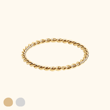 Load image into Gallery viewer, Gold-colored twisted ring on a light yellow background
