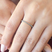 Load image into Gallery viewer, Silver ring on a finger with a blurred background
