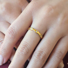 Load image into Gallery viewer, Gold ring with small cubic zirconia stones on a finger

