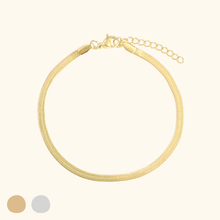 Load image into Gallery viewer, Gold bracelet on a light yellow background
