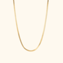 Load image into Gallery viewer, Gold herringbone necklace on a light beige background
