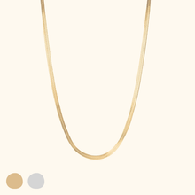 Load image into Gallery viewer, Gold herringbone necklace on a light beige background
