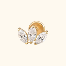 Load image into Gallery viewer, Gold earring with three clear gemstones on a light yellow background
